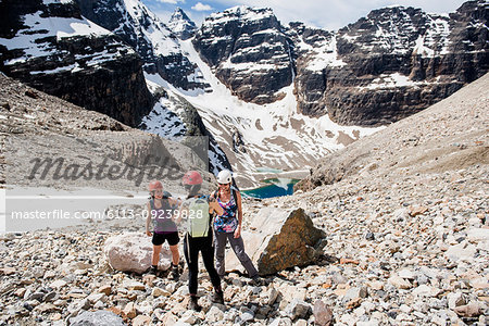 Women hiking in sunny, craggy mountain landscape, Yoho Park, British Columbia, Canada