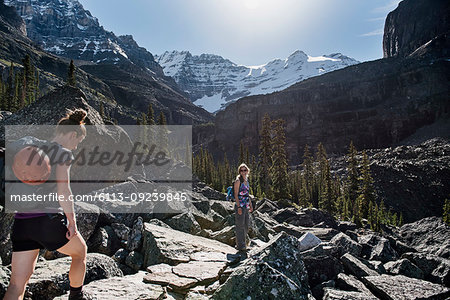 Women hiking in majestic, craggy mountain landscape, Yoho Park, British Columbia, Canada