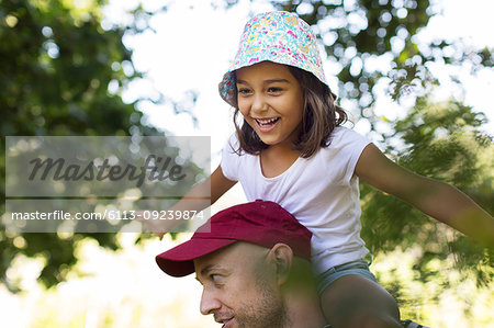 Happy, carefree girl on father's shoulders