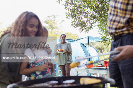 Family barbecuing at campsite