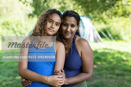 Portrait affectionate mother and daughter at campsite