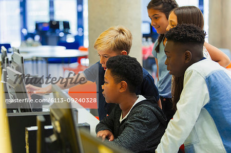 Junior high students using computer in computer lab
