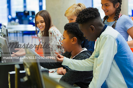 Junior high students using computer in library