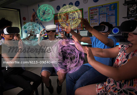 Junior high school students using virtual reality simulators in dark classroom
