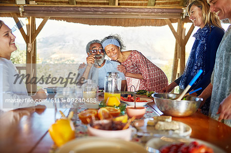 Couple hugging, enjoying healthy breakfast in hut during yoga retreat