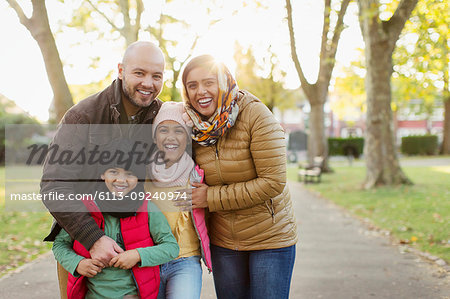 Portrait happy Muslim family in autumn park