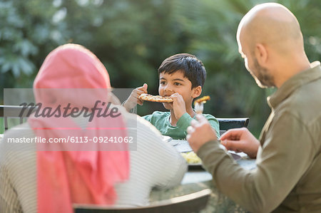 Family eating dinner at patio table