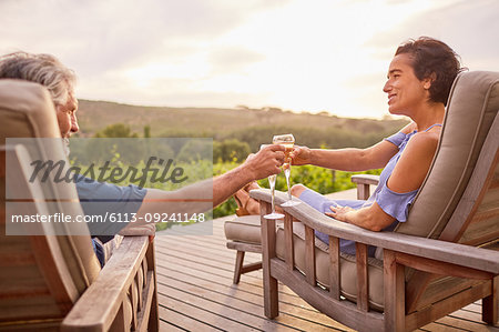 Couple relaxing with champagne on resort patio
