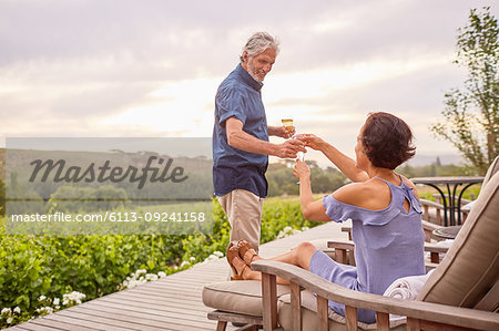 Mature couple drinking champagne on deck