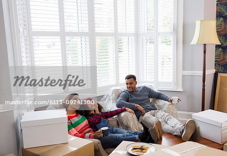 Family taking a break from packing, moving house