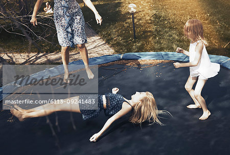 Happy family jumping on trampoline