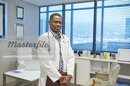 Portrait confident male doctor in clinic doctors office