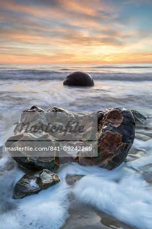 Exposed boulder at Moeraki Beach, Otago, South Island, New Zealand, Pacific Exposed boulder at Moeraki Beach, Otago, South Island, New Zealand, Pacific