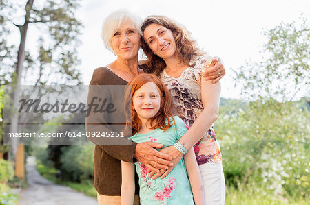 Girl on rural road with mother and grandmother, portrait