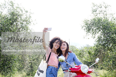 Friends taking selfie in olive grove, Città della Pieve, Umbria, Italy