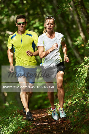 Joggers running in forest