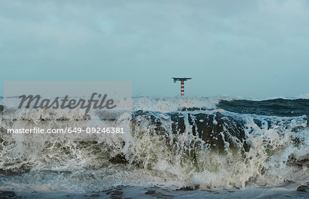 Large waves crashing on dutch shore on stormy day, Rotterdam, Zuid-Holland, Netherlands