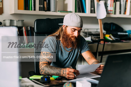 Small business owner doing paperwork in office