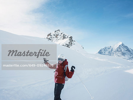 Young woman skier wearing helmet and ski goggles  in snow covered landscape,  portrait, Alpe Ciamporino, Piemonte, Italy