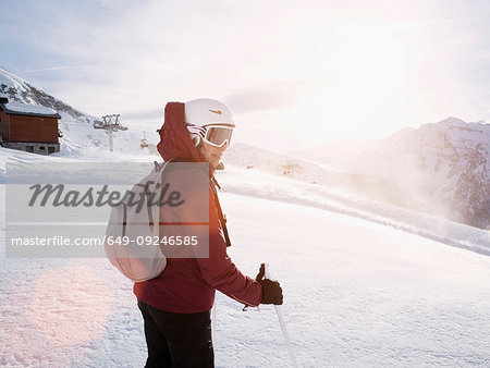 Young woman skier wearing helmet and ski goggles in snow covered landscape,  Alpe Ciamporino, Piemonte, Italy