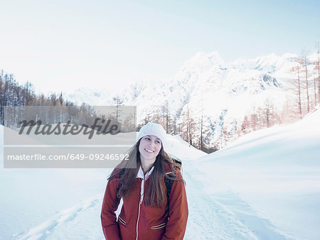 Young woman in knit hat in snow covered landscape,  Alpe Ciamporino, Piemonte, Italy