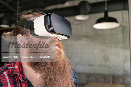 Male hipster using VR goggles