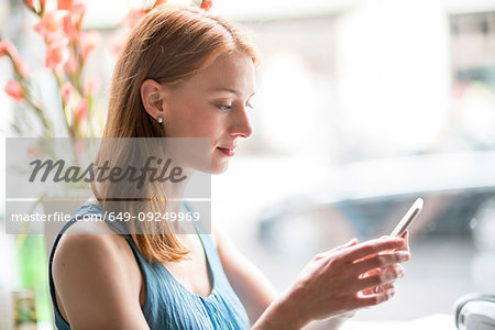 Woman using smartphone in office