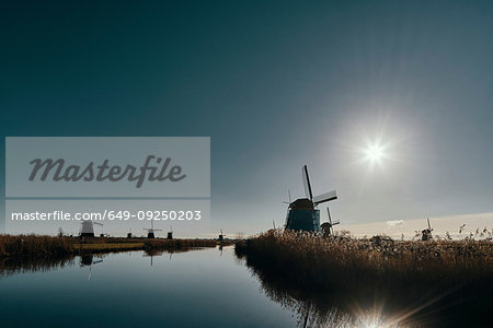 Windmills along canal at dusk, Kinderdijk, Zuid-Holland, Netherlands