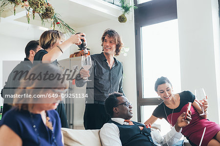 Businessmen and businesswomen celebrating with wine in loft office