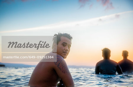 Man and friends enjoying sea at sunset, Pagudpud, Ilocos Norte, Philippines