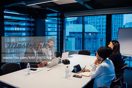 Businessmen and women having discussion over conference table meeting