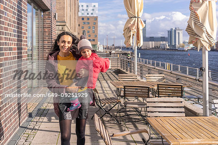 Mother and daughter by river, Berlin, Germany
