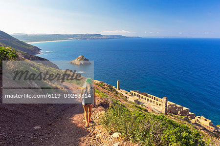 A girl walks on a path to Laveria Lamarmora, Nebida, Iglesias, Sud Sardegna province, Sardinia, Italy, Mediterranean, Europe