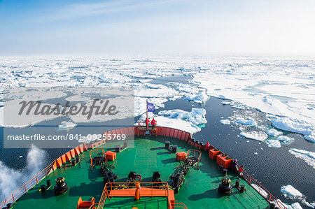 People enjoying the breaking ice on board of an icebreaker, North Pole, Arctic People enjoying the breaking ice on board of an icebreaker, North Pole, Arctic