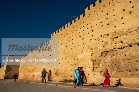 Women in traditional dress walking alongside the walls of the Kasbah Cherada in Fez Medina, UNESCO World Heritage Site, Morocco, North Africa, Africa Women in traditional dress walking alongside the walls of the Kasbah Cherada in Fez Medina, UNESCO World Heritage Site, Morocco, North Africa, Africa