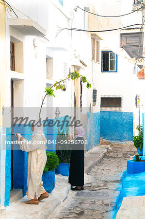 Two woman in local dress at neighbouring front doors, Kasbah des Oudaias, UNESCO World Heritage Site, Rabat, Morocco, North Africa, Africa