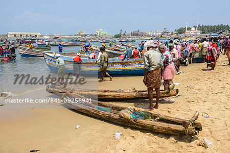 Fishing boats at Vizhinjam beach fish market, near Kovalam, Kerala, India, South Asia