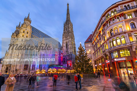 View of St. Stephen's Cathedral, shops and Christmas tree on Stephanplatz at dusk, Vienna, Austria, Europe