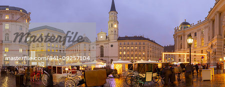 Christmas Market stalls and St. Michael Catholic Church in Michaelerplatz, Vienna, Austria, Europe