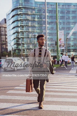 Businessman walking on pedestrian crossing, Milano, Lombardia, Italy