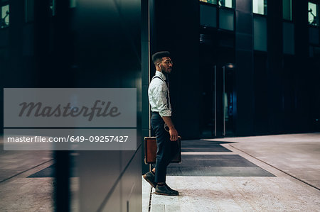 Businessman leaving office building, Milano, Lombardia, Italy