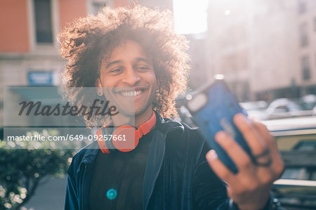 Young man taking selfie in city, Milano, Lombardia, Italy