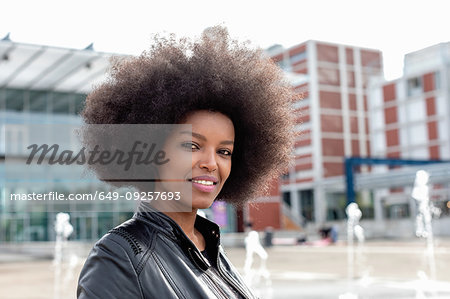 Young woman with afro hair on city concourse, portrait