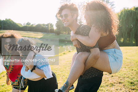 Group of friends having fun by lake