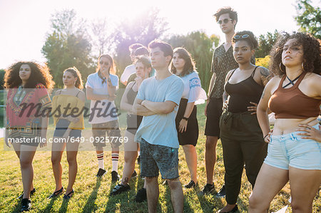 Group of friends posing under hot sun in park