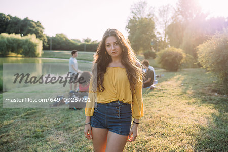 Young woman and friends by lake