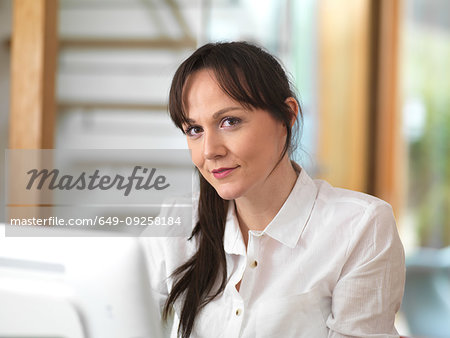 Woman taking a moment and having a think during her working day in the office