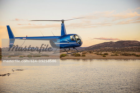 Helicopter flying above watering hole, Cape Town, Western Cape, South Africa