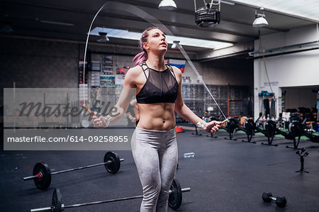 Young woman skipping in gym