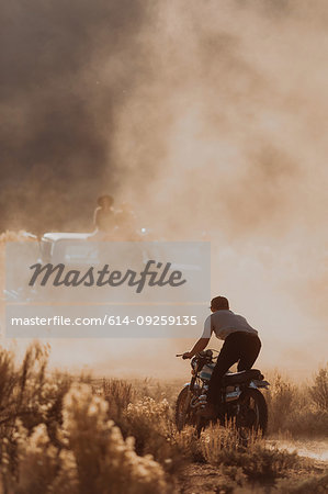 Motorbiker raising dust, Kennedy Meadows, California, US